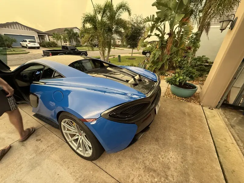Blue McLaren 570S with custom exhaust tips exiting the rear deck