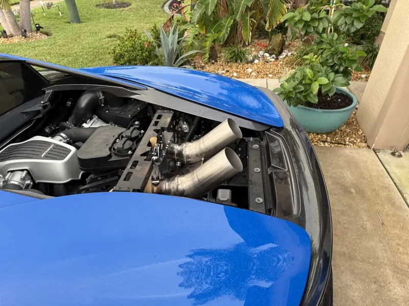 Fabricated exhaust piping routed through the McLaren 570S engine bay