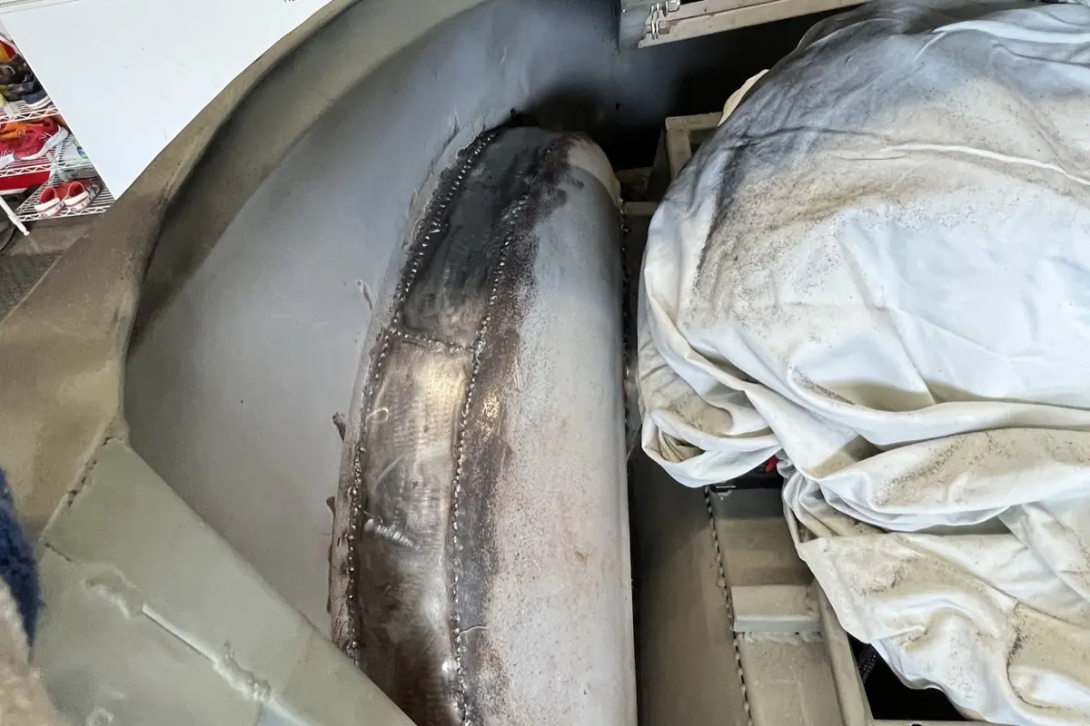 Close-up of a hand-welded seam on a fabricated steel tube