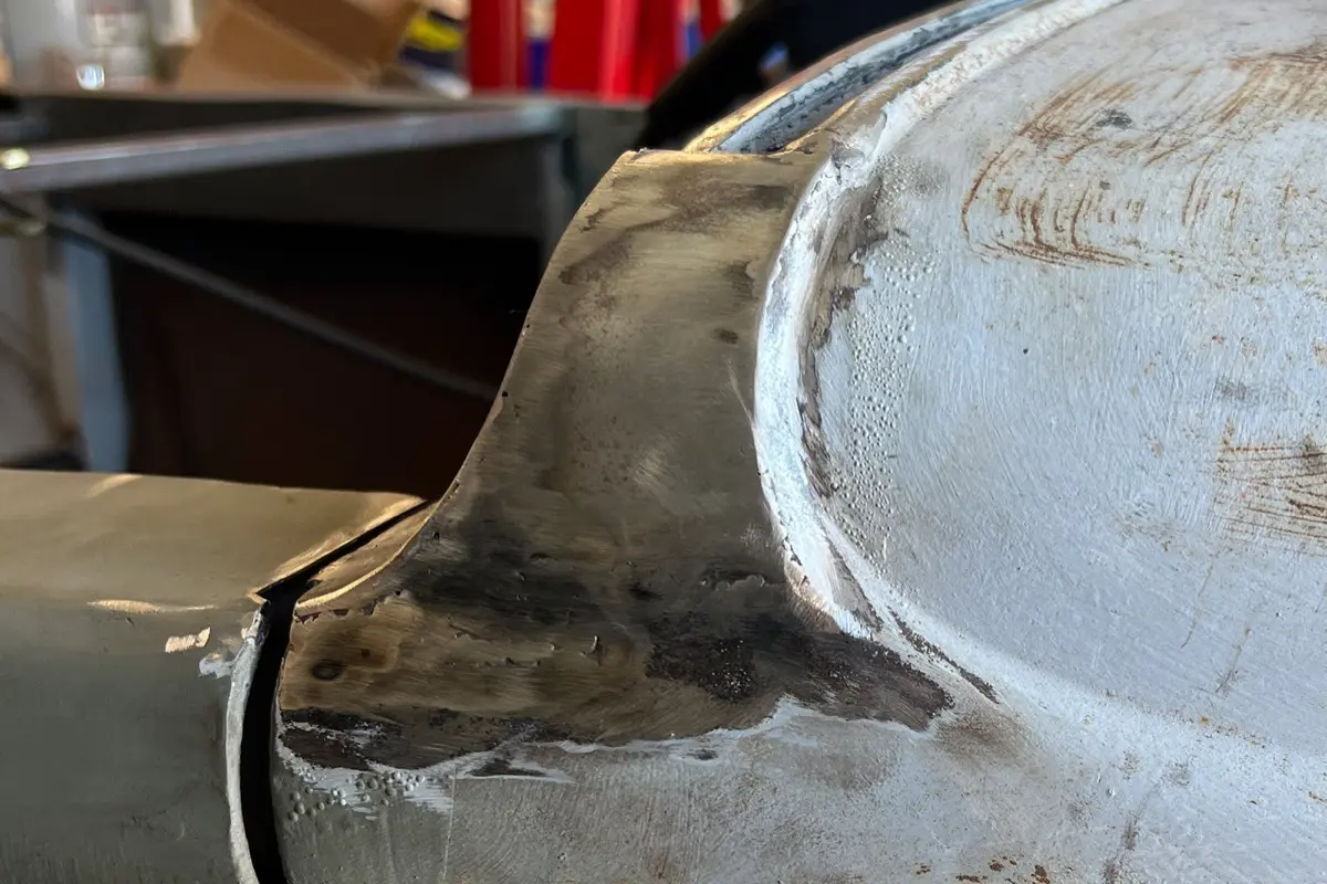 Metal-finished body panel and fender repair on a custom roadster